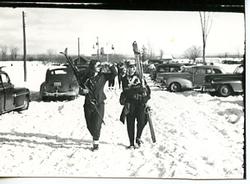 Two Skiers Walking to the Blue Mountain 